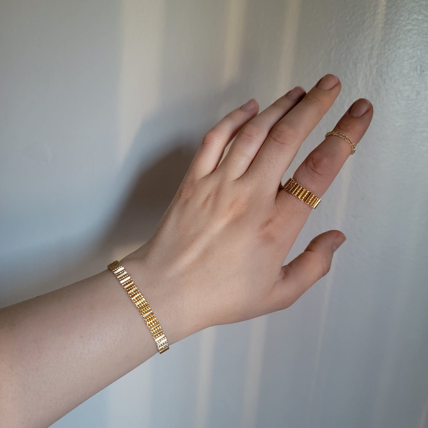 Picture of 5 of 5 of Goddess Bracelet in Gleaming Gold model hand wearing it